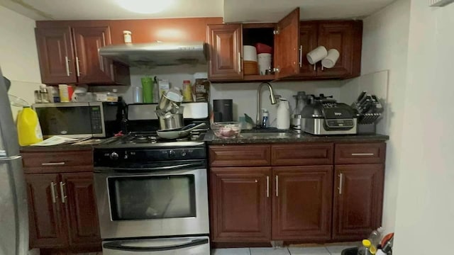 kitchen featuring open shelves, appliances with stainless steel finishes, and a sink