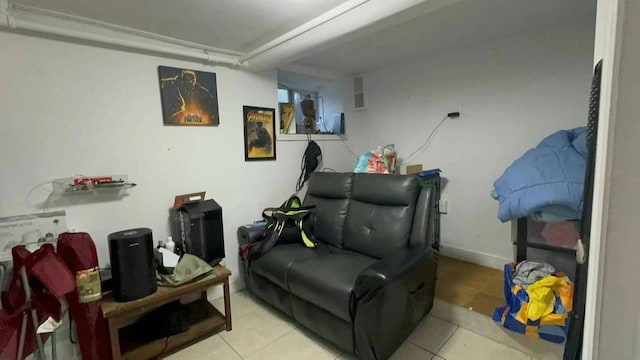 sitting room featuring light tile patterned floors and baseboards