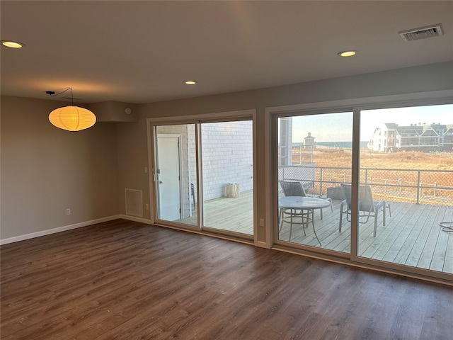 doorway to outside featuring dark wood-style flooring, visible vents, and recessed lighting