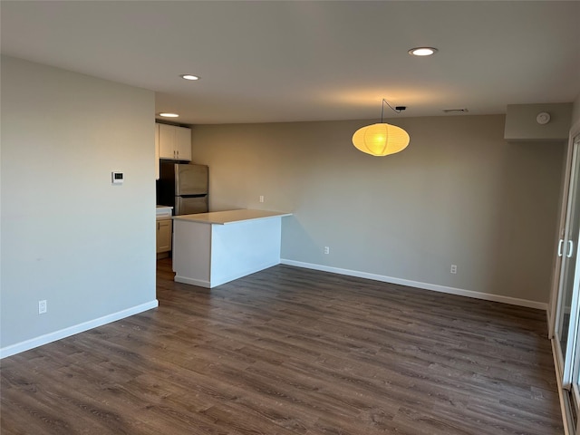 interior space featuring dark wood-style flooring, recessed lighting, visible vents, and baseboards