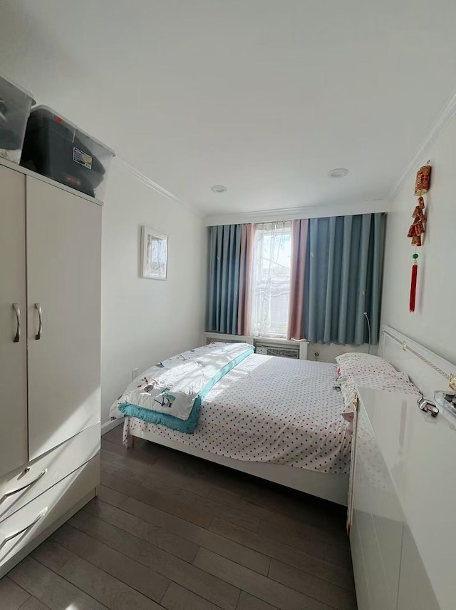 bedroom featuring dark wood-style floors and crown molding