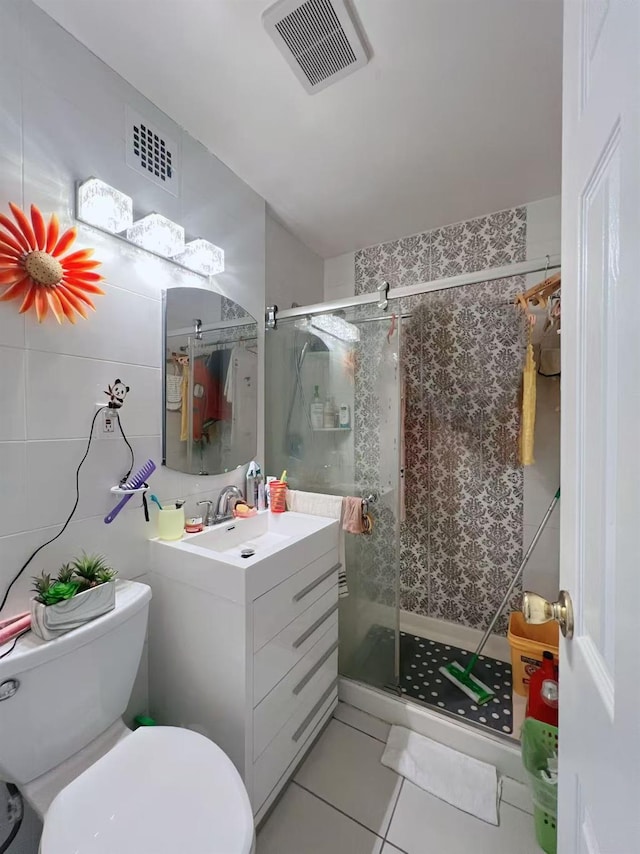 full bathroom featuring vanity, a shower stall, visible vents, and tile patterned floors