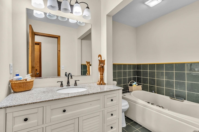 full bath featuring toilet, vanity, a bath, and tile patterned floors