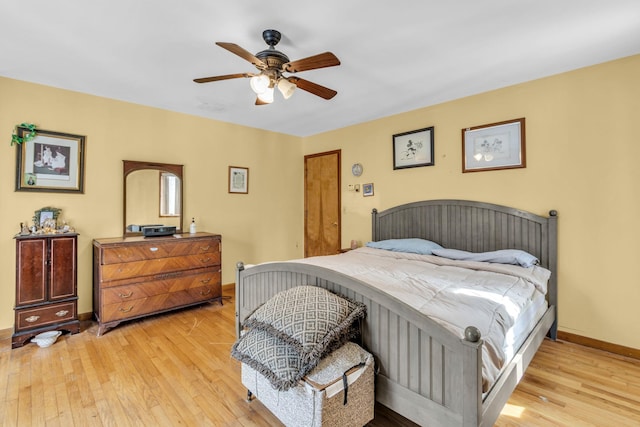 bedroom featuring a ceiling fan, light wood-type flooring, and baseboards