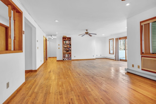 unfurnished room with light wood finished floors, recessed lighting, a ceiling fan, a baseboard heating unit, and baseboards