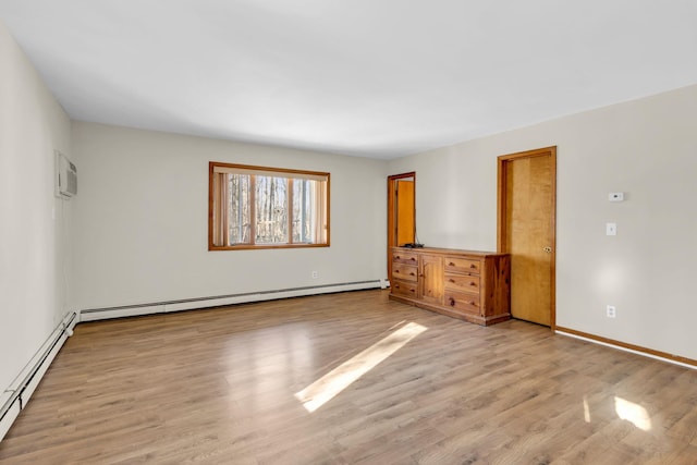 unfurnished bedroom featuring a baseboard radiator, a baseboard heating unit, light wood-style floors, an AC wall unit, and baseboards