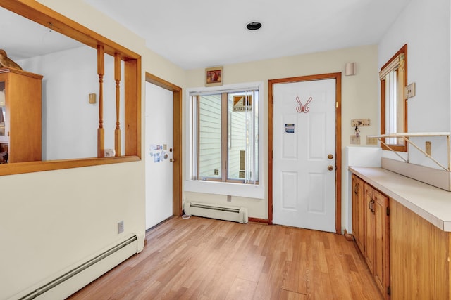 entrance foyer featuring light wood finished floors and baseboard heating