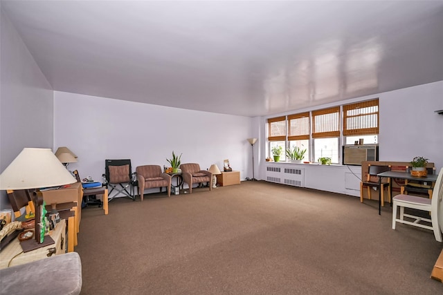 interior space with carpet floors, cooling unit, and radiator heating unit