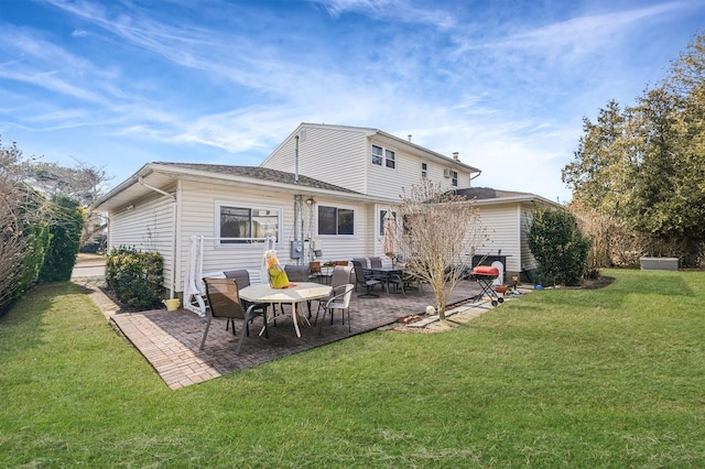 back of house with a yard and a patio area