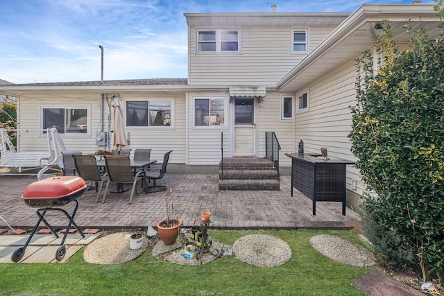 rear view of property featuring entry steps and a patio