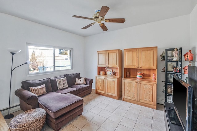 living area with light tile patterned floors and a ceiling fan