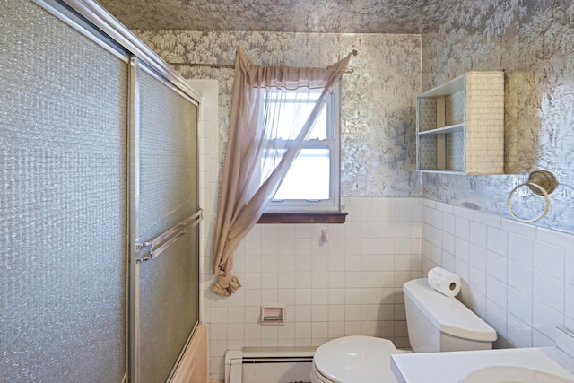 bathroom featuring toilet, a wainscoted wall, vanity, baseboard heating, and wallpapered walls