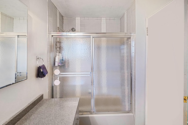 bathroom with shower / bath combination with glass door