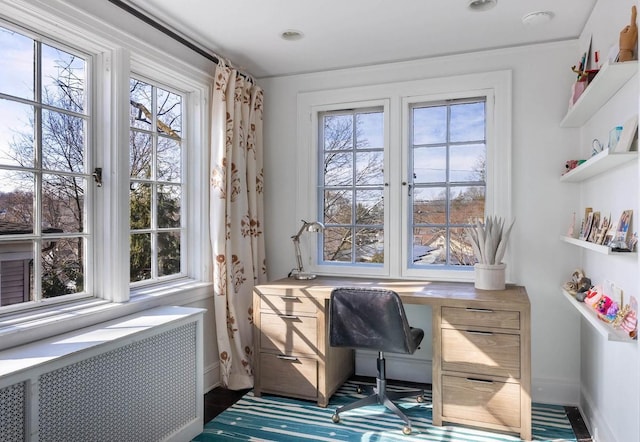 office space featuring radiator and baseboards