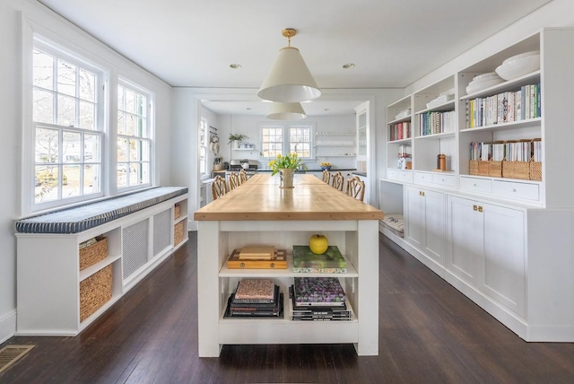 dining room featuring visible vents and dark wood finished floors