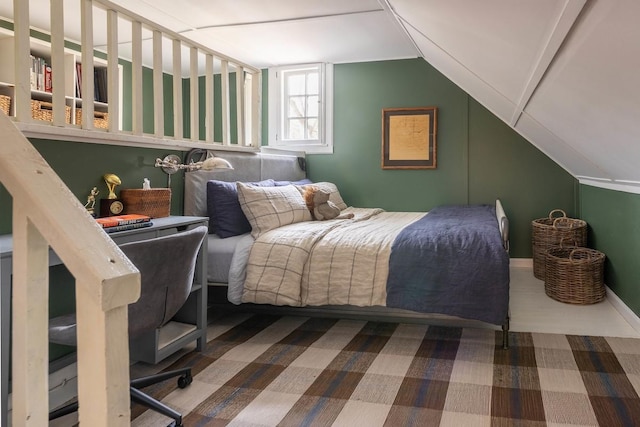 bedroom with vaulted ceiling and baseboards