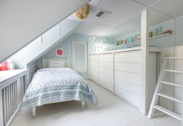 bedroom featuring visible vents and wood finished floors