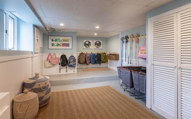 mudroom with concrete flooring, a paneled ceiling, and recessed lighting