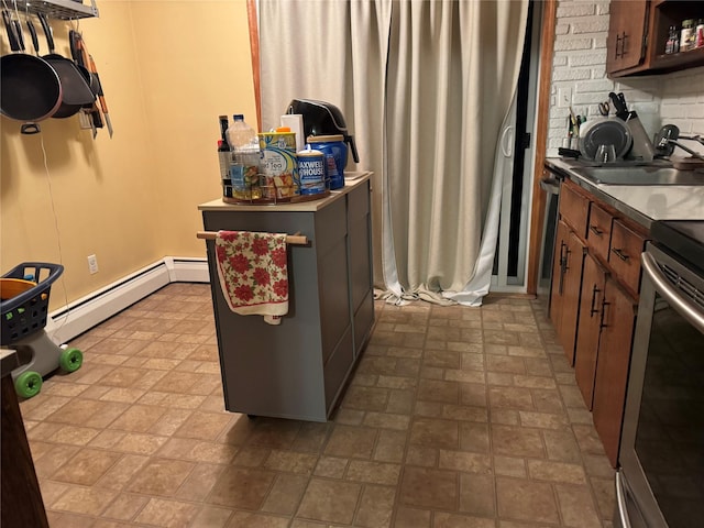 kitchen with open shelves, backsplash, baseboard heating, appliances with stainless steel finishes, and a sink