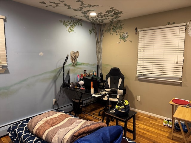 office area with wood finished floors and baseboards