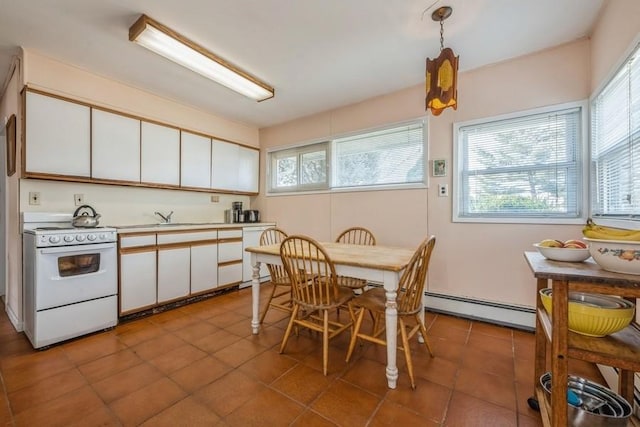 kitchen featuring a baseboard heating unit, white appliances, and plenty of natural light