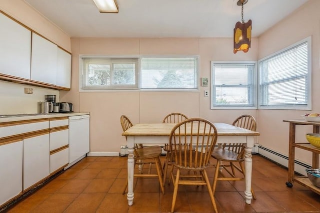 tiled dining space featuring a baseboard heating unit