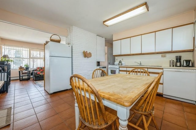 dining room featuring a baseboard heating unit and tile patterned flooring