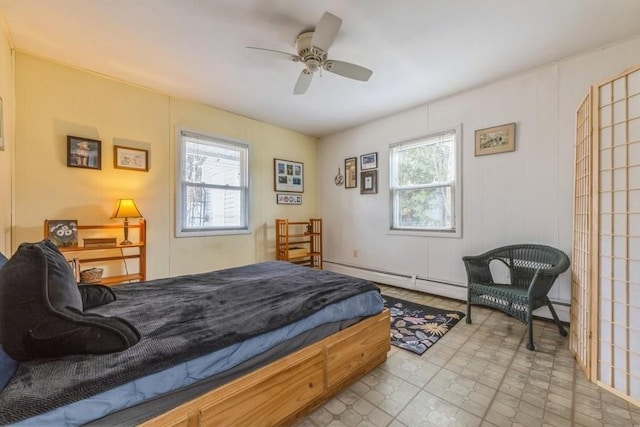 bedroom featuring a baseboard heating unit, multiple windows, and ceiling fan