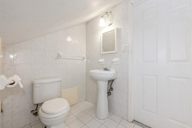 bathroom featuring tile walls, a sink, toilet, and tile patterned floors