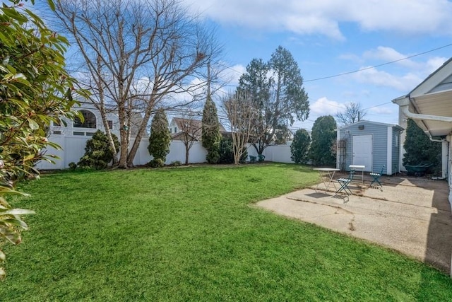 view of yard with a patio area, a fenced backyard, an outdoor structure, and a shed