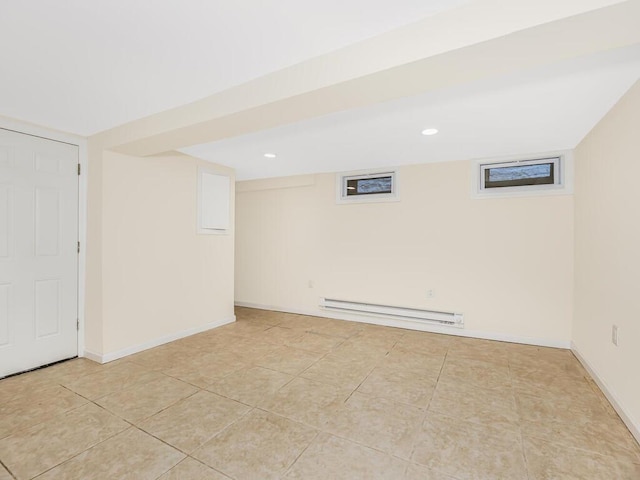 finished basement with recessed lighting, baseboards, baseboard heating, and light tile patterned floors