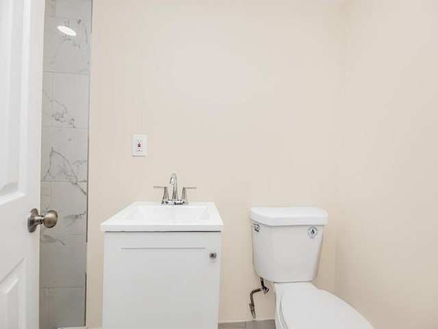 bathroom featuring toilet and vanity