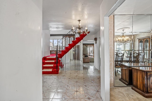 entryway featuring a notable chandelier and stairs