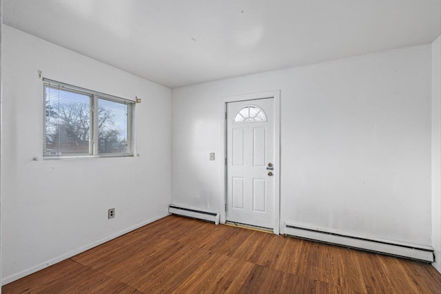 entrance foyer featuring a baseboard heating unit, baseboards, baseboard heating, and wood finished floors