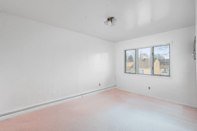 unfurnished room featuring carpet and a baseboard radiator