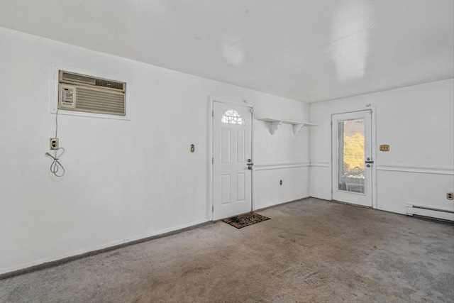 entrance foyer with baseboard heating, carpet, and a wall mounted air conditioner