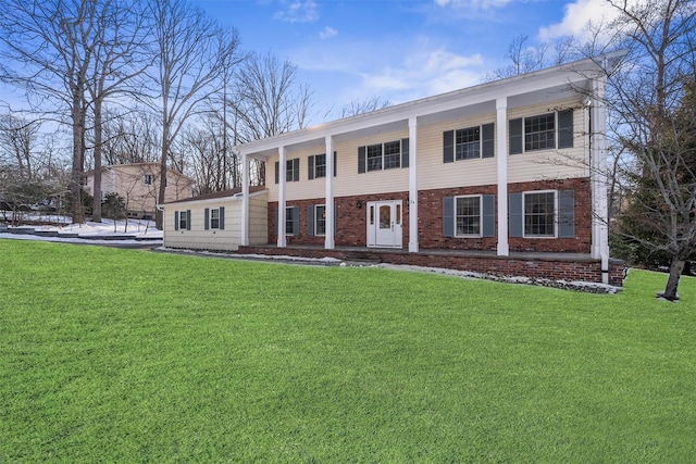 greek revival house with brick siding and a front lawn