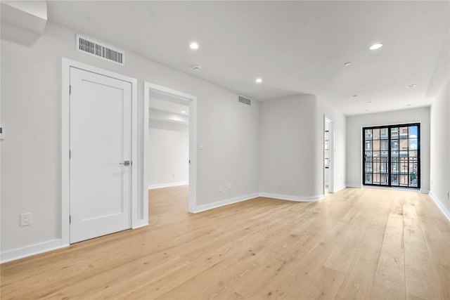 spare room with recessed lighting, baseboards, visible vents, and light wood finished floors