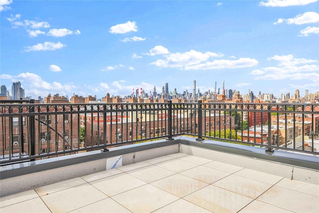 view of patio featuring a balcony and a city view