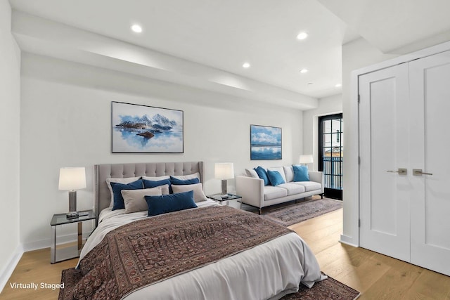 bedroom with recessed lighting, light wood-style flooring, and baseboards