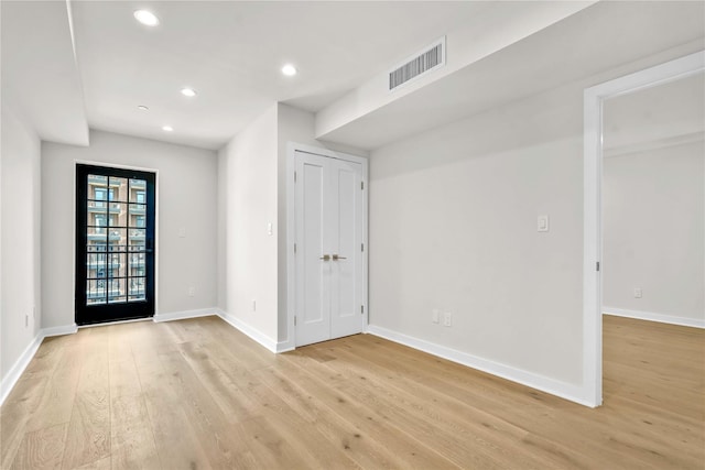 unfurnished room with recessed lighting, baseboards, light wood-style floors, and visible vents