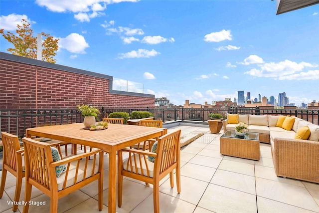 view of patio with an outdoor hangout area, a view of city, and outdoor dining area