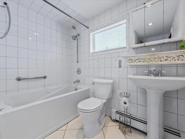 full bath featuring toilet, tile patterned floors, tub / shower combination, baseboard heating, and tile walls