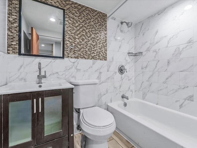 full bathroom featuring bathing tub / shower combination, tile walls, tasteful backsplash, toilet, and vanity