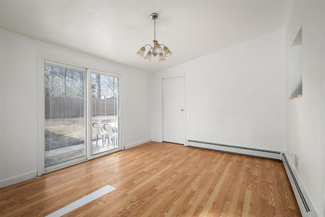 unfurnished room with a baseboard radiator, a notable chandelier, light wood-style flooring, and baseboards