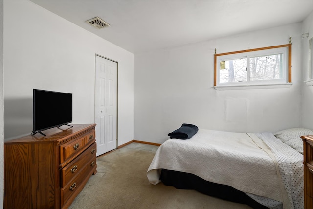 bedroom featuring light colored carpet, a closet, visible vents, and baseboards