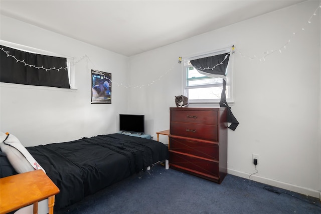 bedroom featuring carpet floors and baseboards