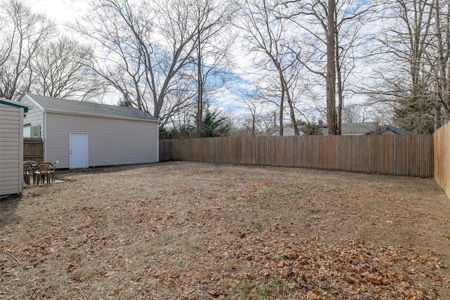 view of yard with an outbuilding and a fenced backyard