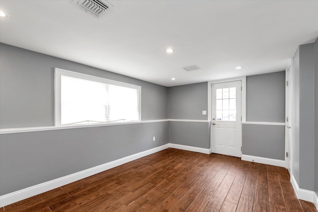 unfurnished room featuring recessed lighting, visible vents, baseboards, and wood finished floors