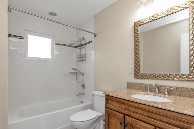 bathroom with tub / shower combination, vanity, and toilet